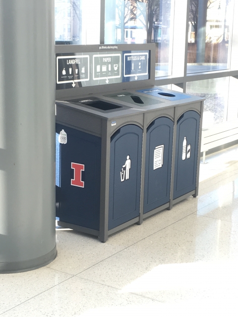 a three stream waste collection bin is shown with a window behind it