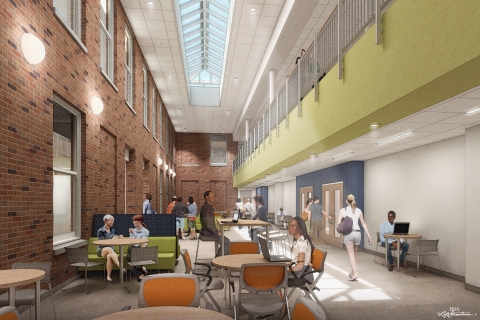 Students and faculty walking through the atrium or conversing in sitting areas.