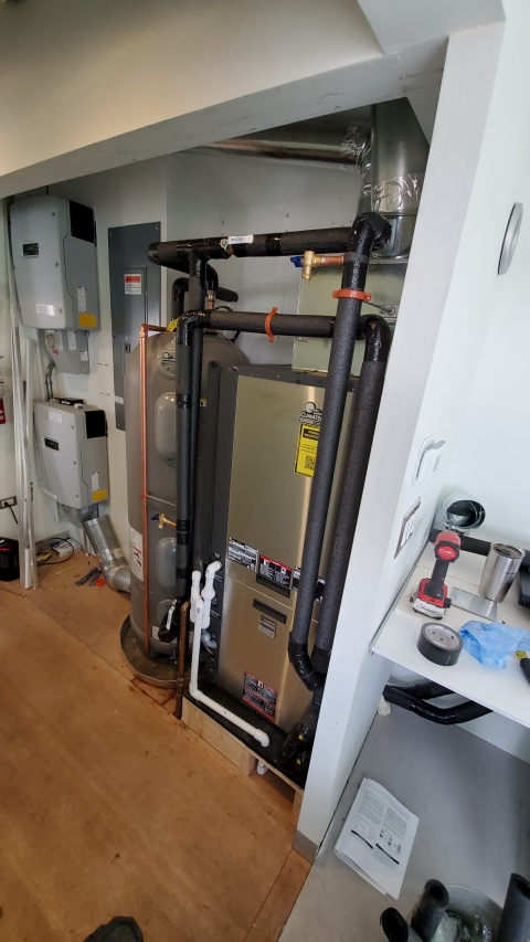 geothermal system pipes and heat pump inside building